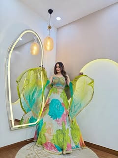 Parrot-green lehenga mid-twirl in the studio arch