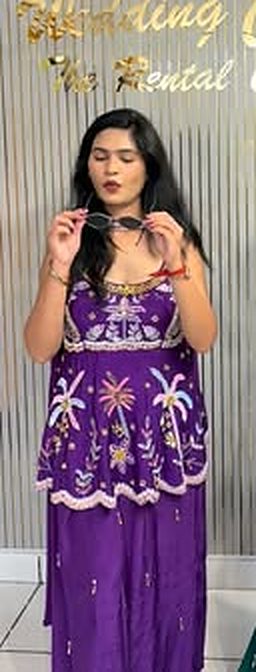 Purple sequin sharara in front of the Wedding Colors sign