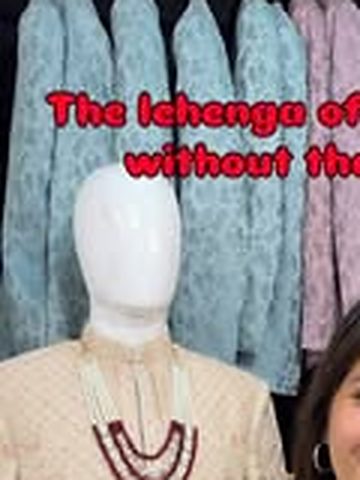 Ivory sherwani with mala on a mannequin